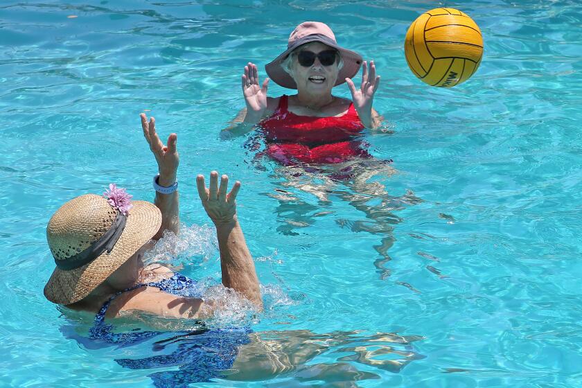 Members of Mermaids swim group play water polo to classic songs from the 50's and 60's during their Deep Water Aquafit class, two-hour Mermaid-a-Thon to raise funds for the local Newport-Mesa Family YMCA on Friday.