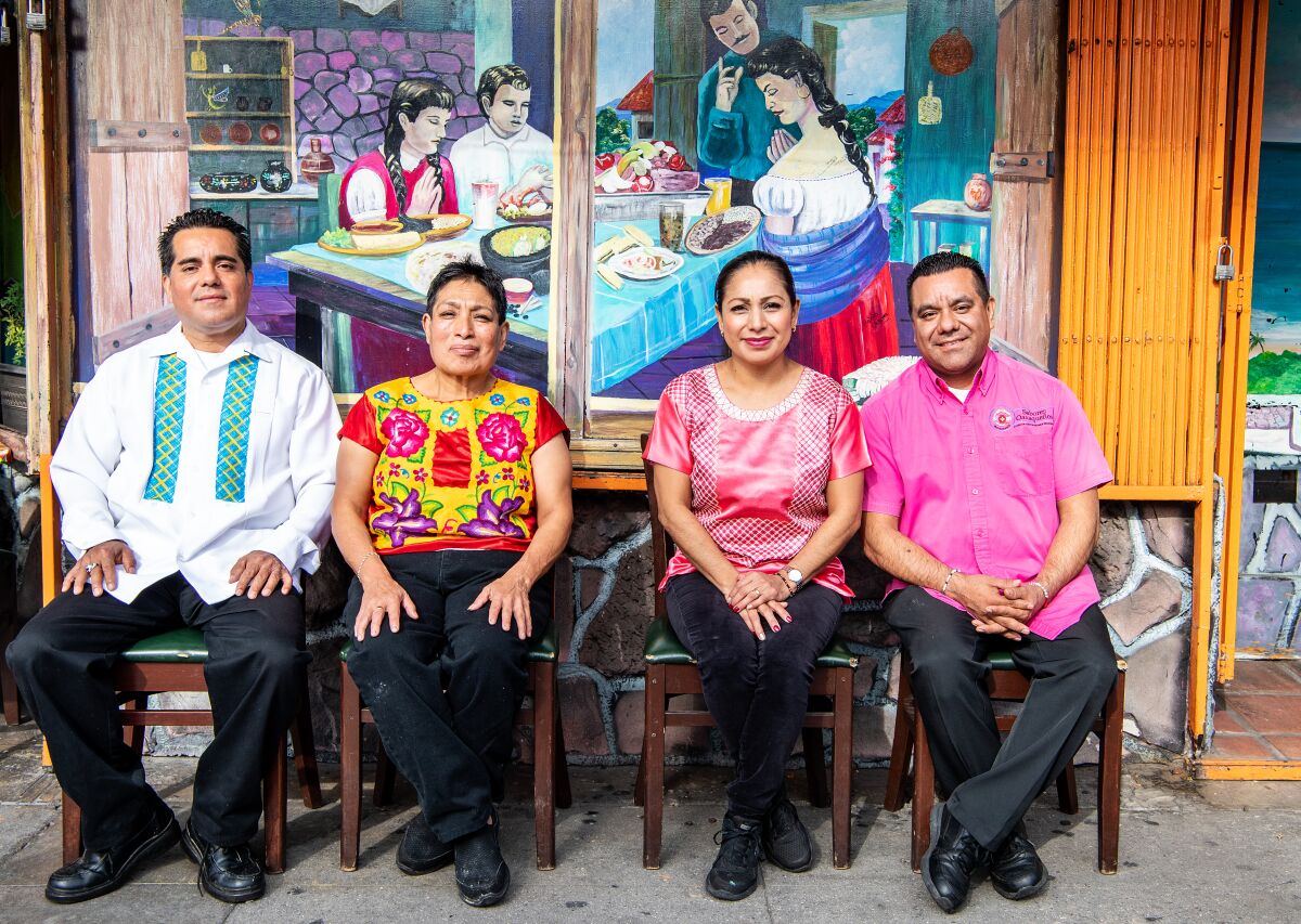 Sabores Oaxaqueños owners Germán Granja, left, his brother Valentín and wife Analilia, far right, and head chef Dominga Velasco Rodriguez outside their restaurant in Koreatown.