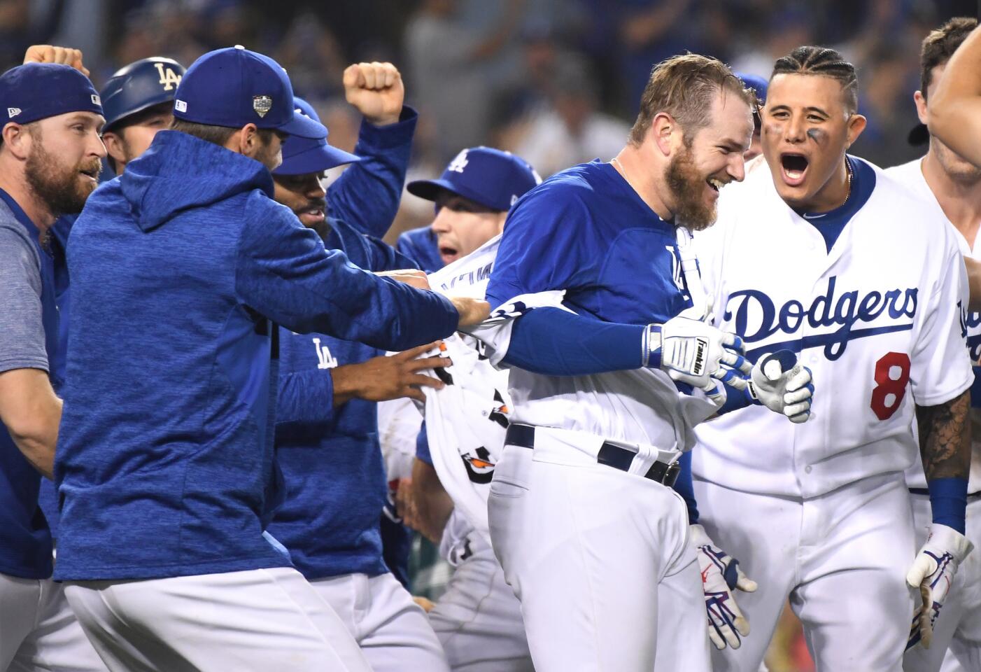 Dodgers Max Muncy, second from right, celebrates his walk-off home run against the Red Sox in the bottom of the 18th inning.