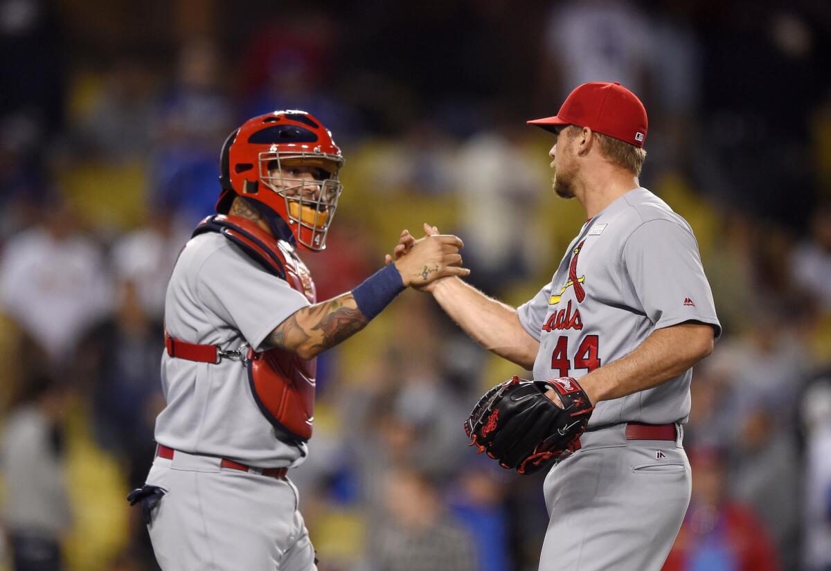Cardinals catcher Yadier Molina, left, and relief pitcher Trevor Rosenthal congratulate each other after the Cardinals defeated the Dodgers, 5-2.