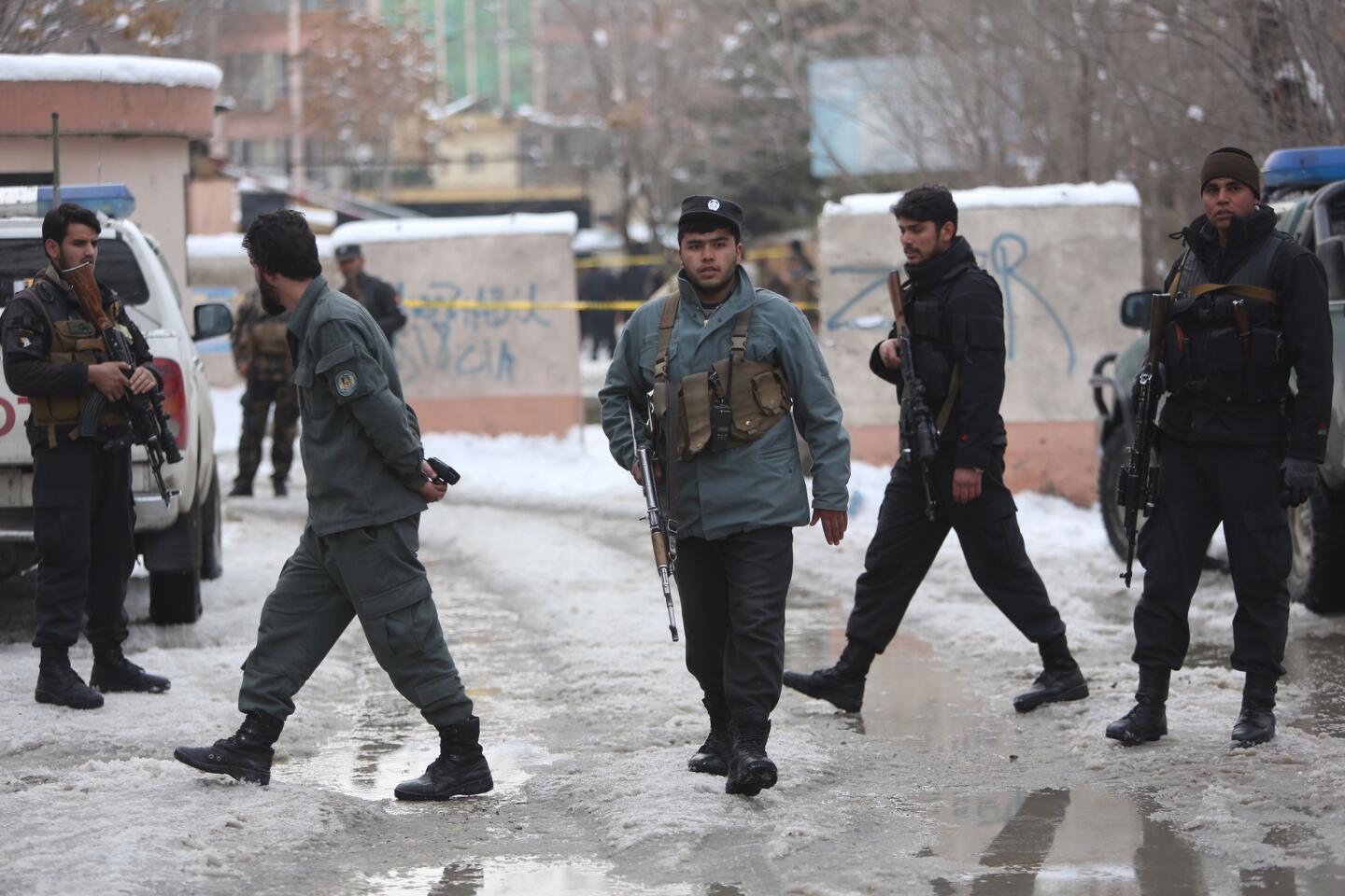 Police officers inspect the site of suicide attack at the Supreme Court in Kabul, Afghanistan, on Feb. 7, 2017.