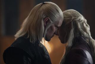 a man and woman with long blond hair with their faces close together