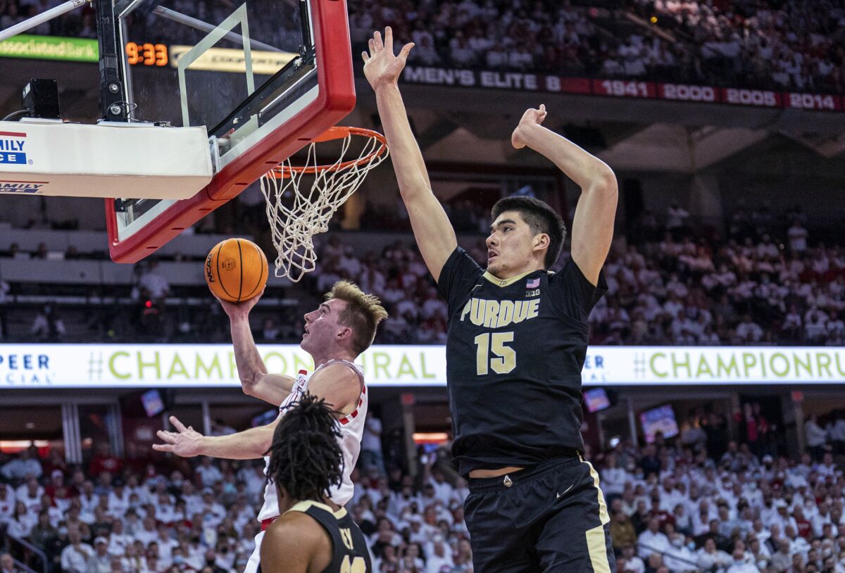 Wisconsin's Tyler Wahl (5) shoots as Purdue's Jaden Ivey (23) and Zach Edey, right, watch during the second half of an NCAA college basketball game Tuesday, March 1, 2022, in Madison, Wis. Wahl had a team-high 19 points in Wisconsin's 70-67 win. (AP Photo/Andy Manis)