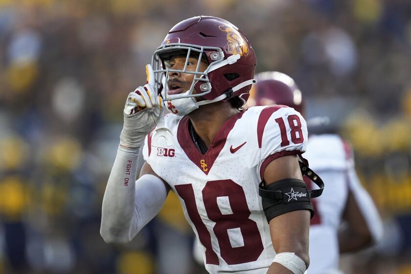 USC linebacker Eric Gentry raises his hand toward his face and shushes the rowdy Michigan crowd 