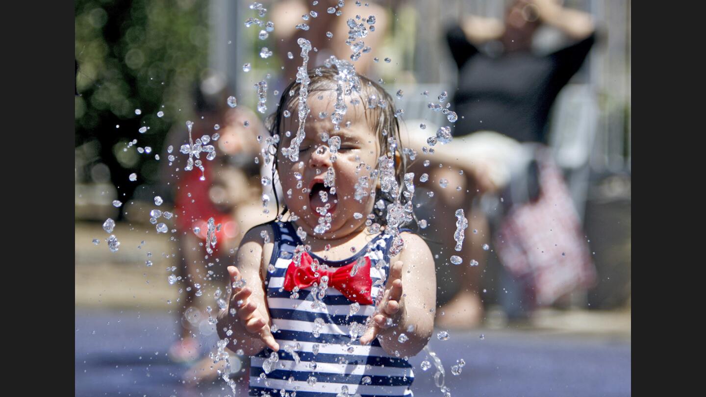 Olivia Lizaola, 1 of Los Angeles, walks through a water sprinkler at the Pacific Park Splash Pads, in Glendale on a hot Wednesday morning, June 21, 2017. Temperatures were expected to remain hot for a few days.