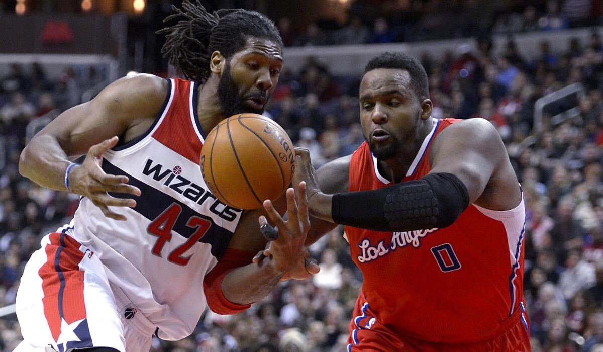 Wizards power forward Nene drives against Clippers power forward Glen Davis in the second half Friday night.