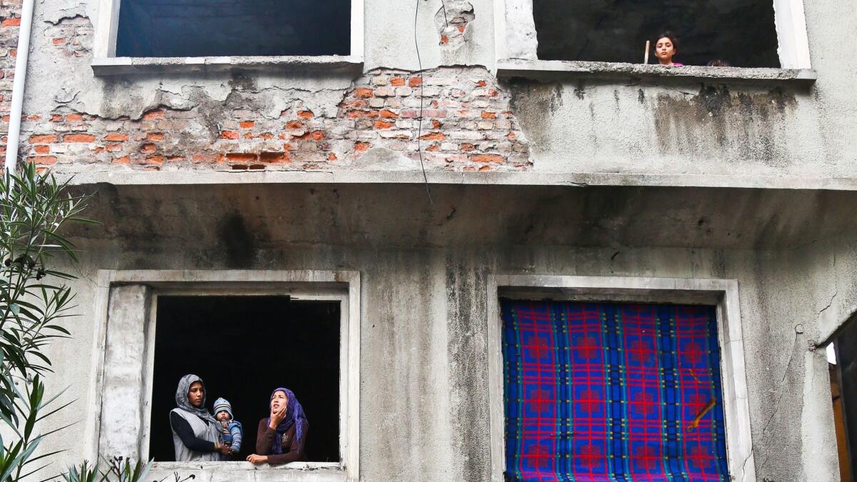 Syrian refugees look out from an evacuated house in the Kucukpazar district of Istanbul, Turkey.