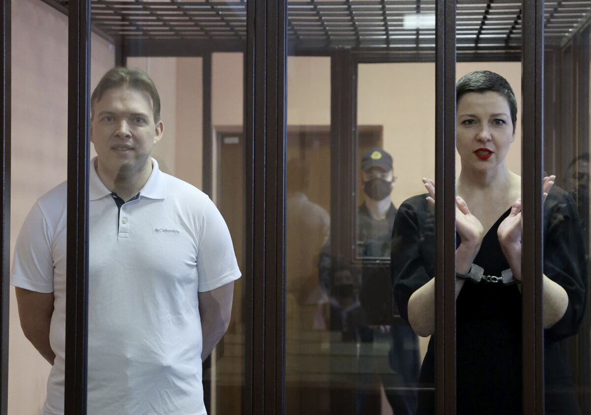 Belarus' opposition activists Maria Kolesnikova, right, and Maxim Znak attend a court hearing in Minsk, Belarus, Monday, Sept. 6, 2021. A court in Belarus on Monday sentenced two leading opposition activists to lengthy prison terms, the latest move in the relentless crackdown Belarusian authorities unleashed on dissent in the wake of last year's months-long anti-government protests. Maria Kolesnikova, a top member of the opposition Coordination Council, has been in custody since her arrest last September. A court in Minsk found her guilty of conspiring to seize power, creating an extremist organization and calling for actions damaging state security and sentenced her to 11 years in prison. Znak was sentenced to 10 years in prison. (Ramil Nasibulin/BelTA pool photo via AP)