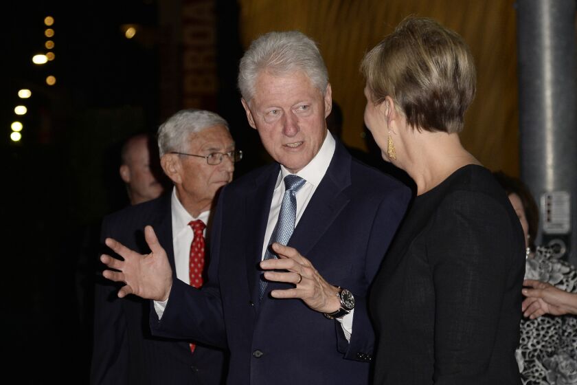 Former President Clinton stands with Joanne Heyler and Eli Broad during the Broad museum's party on Sept. 18.