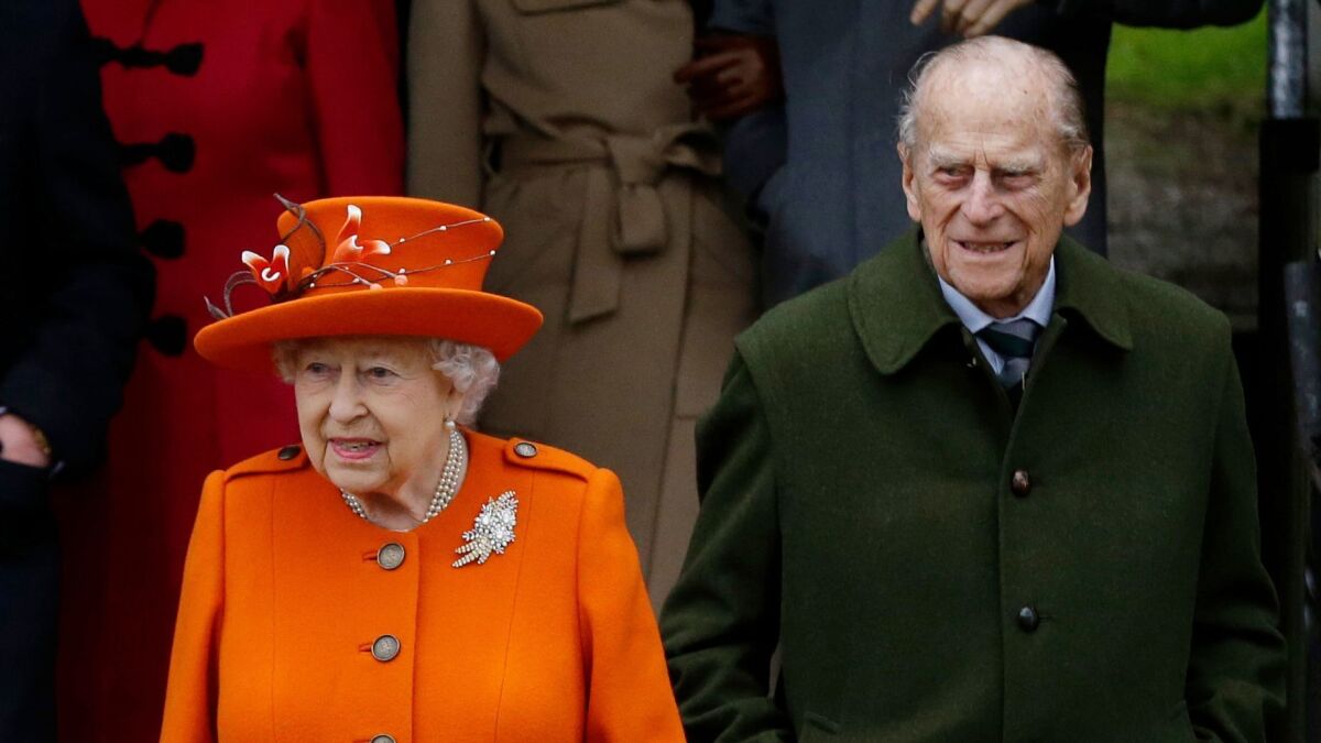 Britain's Queen Elizabeth II and Prince Philip wait for their car following the traditional Christmas Day church service at St. Mary Magdalene Church in Sandringham, England, in 2017.