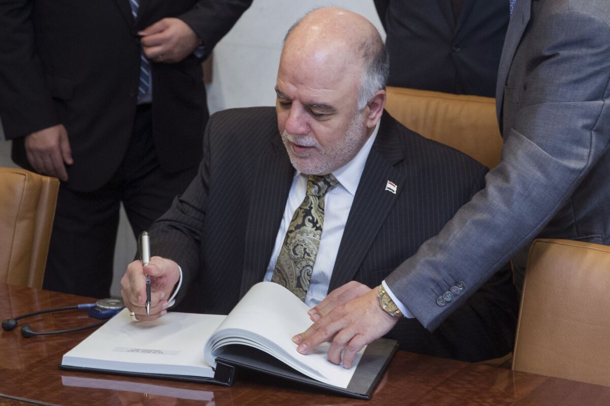 Iraqi Prime Minister Haider Abadi signs the guestbook during the United Nations General Assembly on Thursday.