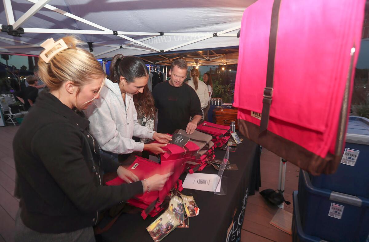 Sarah Weismann and Savannah Lyons, from left, shop Nalu clothing and accessories during Monday's pop-up event.