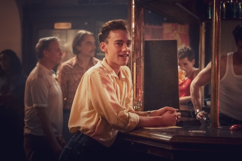 Olly Alexander as Ritchie, a young gay character, in a bar in "It's a Sin."
