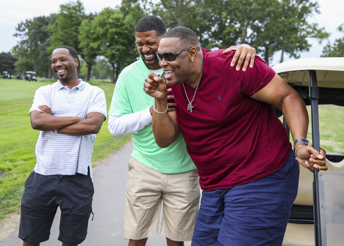 Former NBA players Jalen Rose, center, and Rick Mahorn, right, attend the Jalen Rose Leadership Academy Celebrity Golf Classic, presented by Tom Gores and Platinum Equity in August.