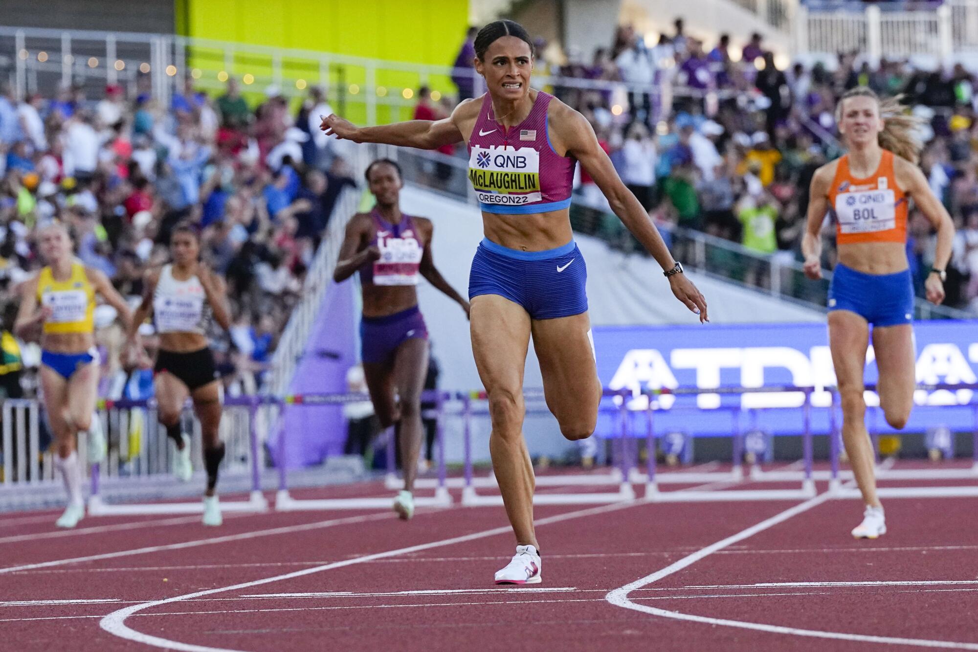Sydney McLaughlin-Levrone breaks her own world record to win gold in the women's 400-meter hurdles.