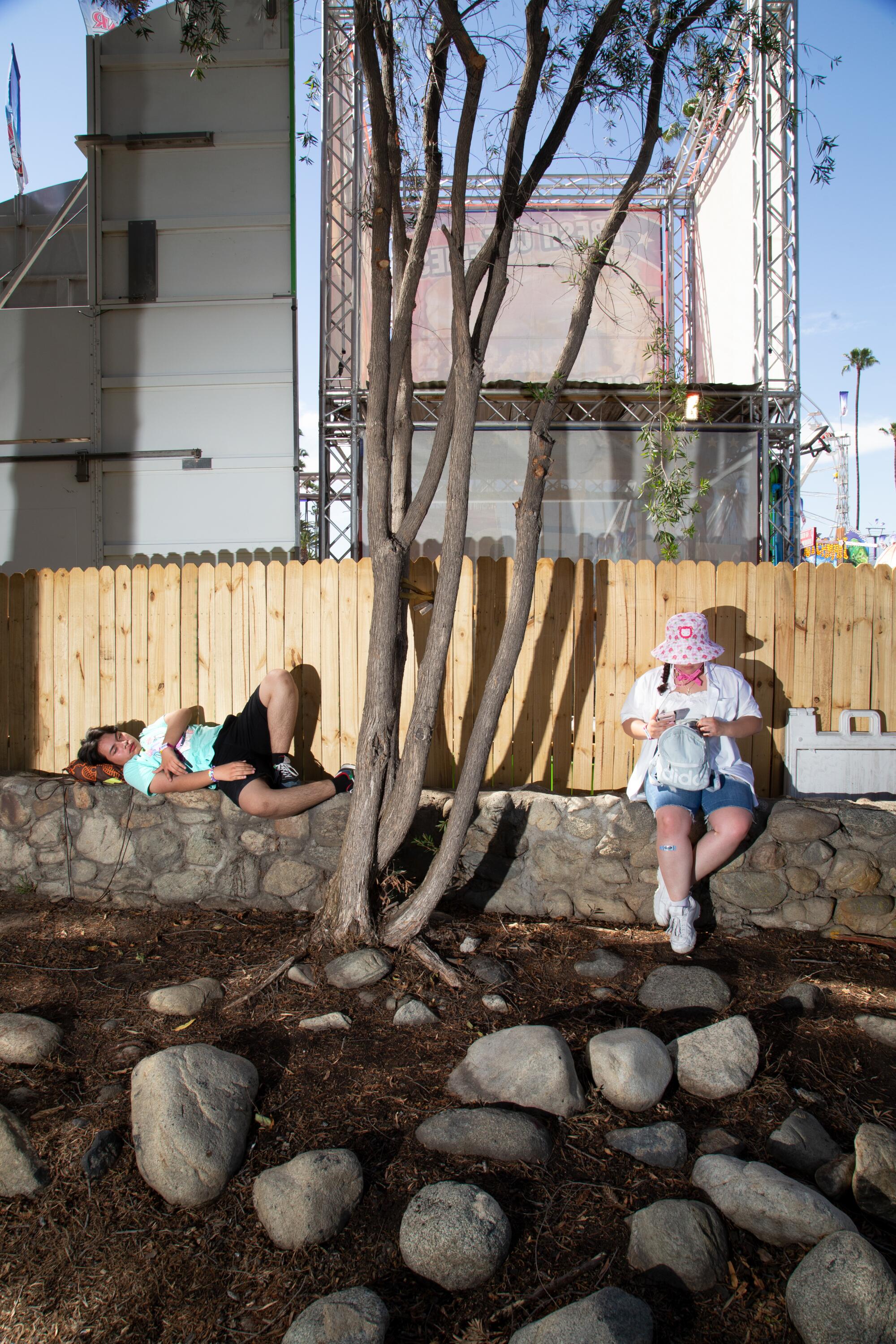 Two people wait outside the Los Angeles County Fair.