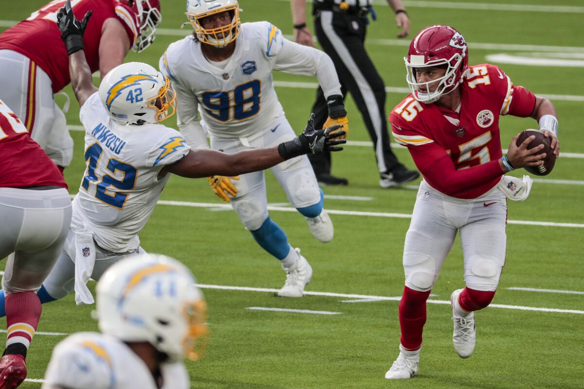 Chiefs quarterback Patrick Mahomes avoids the Chargers' defense.