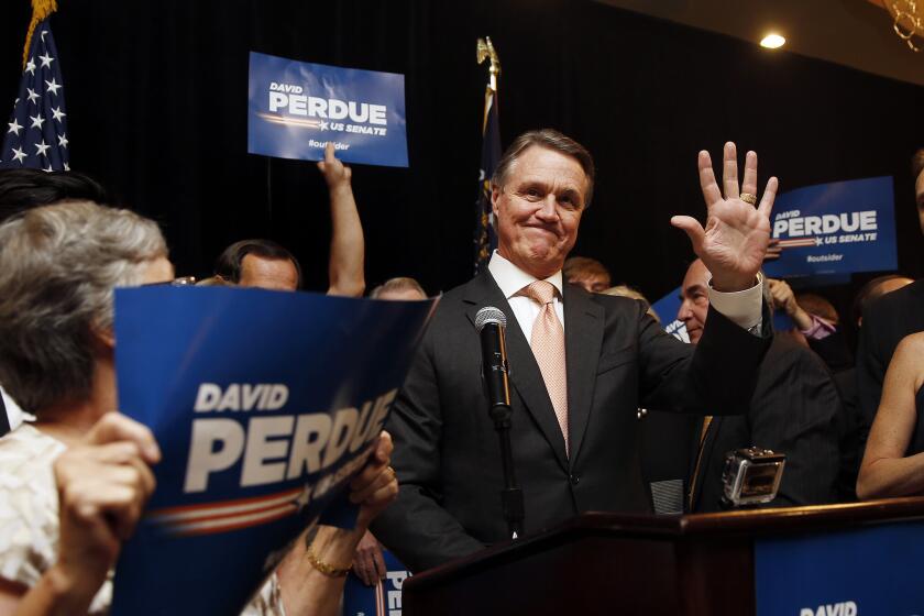David Perdue waves to supporters after declaring victory Tuesday in the Republican primary runoff for a U.S. Senate seat from Georgia.