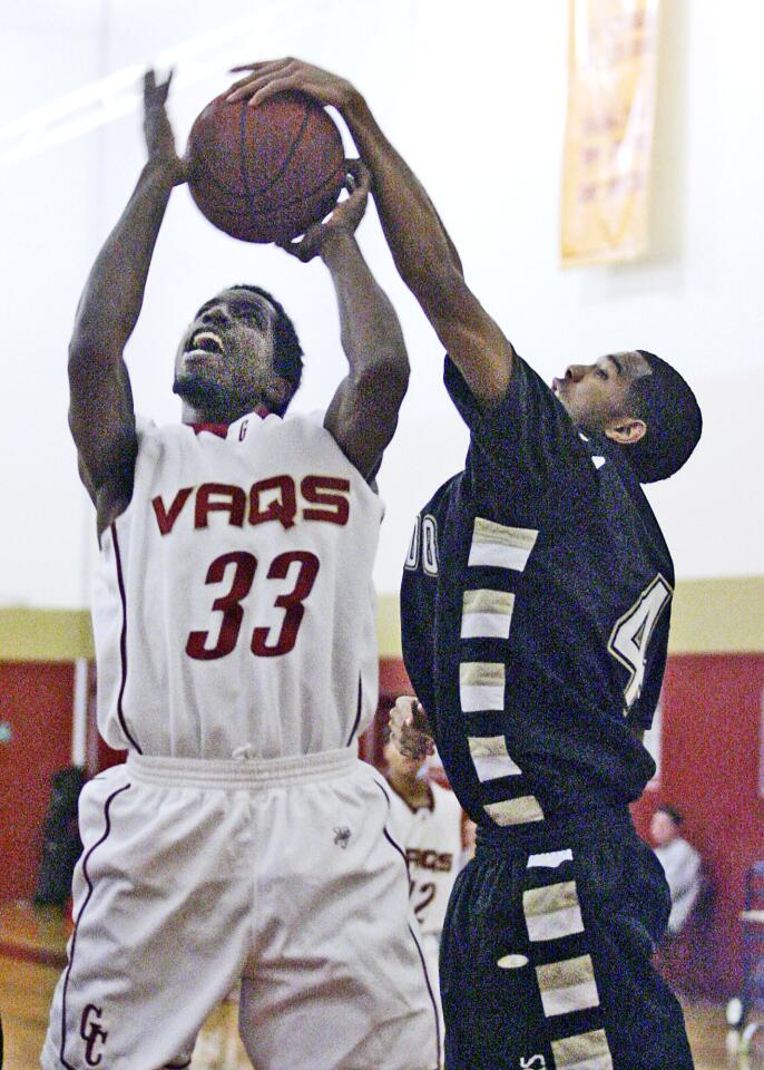 GCC's Mike Johnson powers toward the net but his shot is blocked by Rio Hondo's Amir Smith in the first half of the opening round of the Glendale College Vaquero Classic at GCC on Wednesday, December 12, 2012.