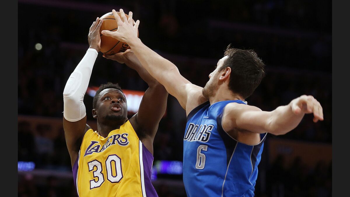Lakers forward Julius Randle, shooting over Dallas Mavericks center Andrew Bogut, has two triple-doubles this season and three in two full seasons.