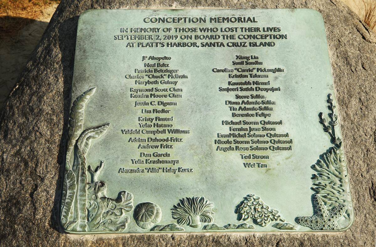 A plaque memorial on a rock lists those who died in the Conception boat fire