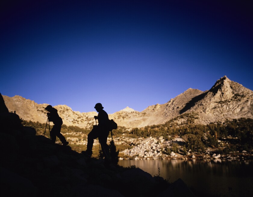 Hikers silhouetted against the mountains