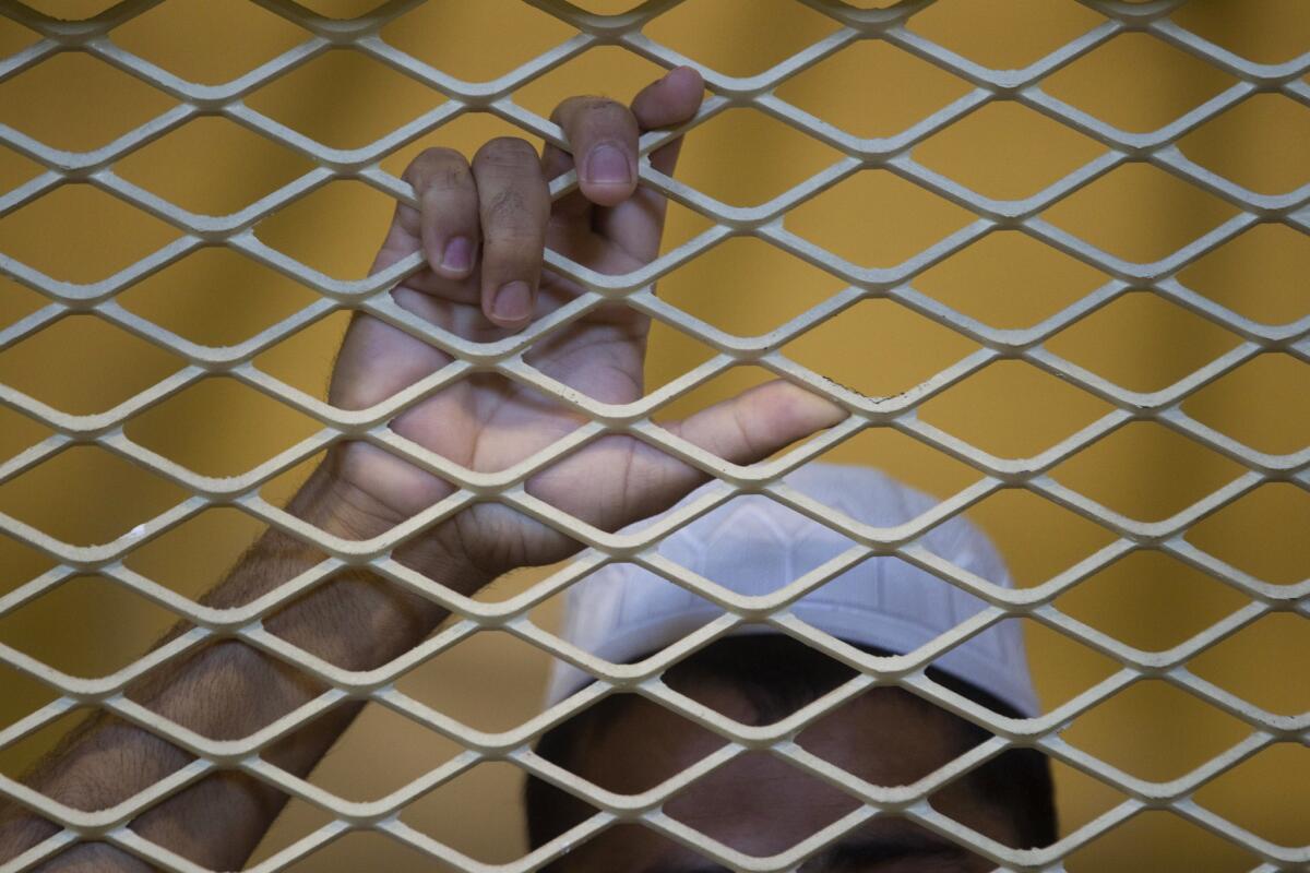 In this file photo reviewed by the U.S. military, a detainee stands in a cell inside the Parwan detention facility near Bagram, north of Kabul, Afghanistan.