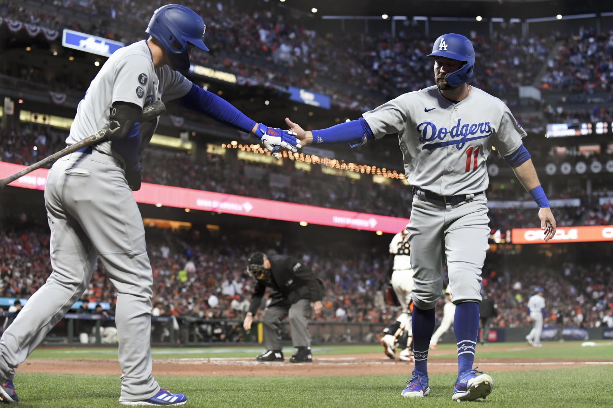  Dodgers' AJ Pollock, right, celebrates with Corey Seager after scoring.