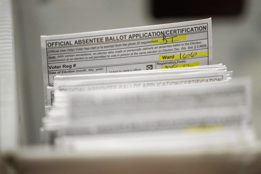 FILE - Absentee ballots are seen during a count at the Wisconsin Center for the midterm election Tuesday, Nov. 8, 2022, in Milwaukee. A federal judge has thrown out a lawsuit brought by Democrats that challenged Wisconsin’s witness requirements for absentee voting, a ruling that keeps the law in place with the presidential election six months away. U.S. District Court Judge James Peterson tossed the lawsuit Thursday, May 9, 2024, saying the fact that the law has stood unchallenged in one form or another since the 1960s was “telling.”(AP Photo/Morry Gash, File)