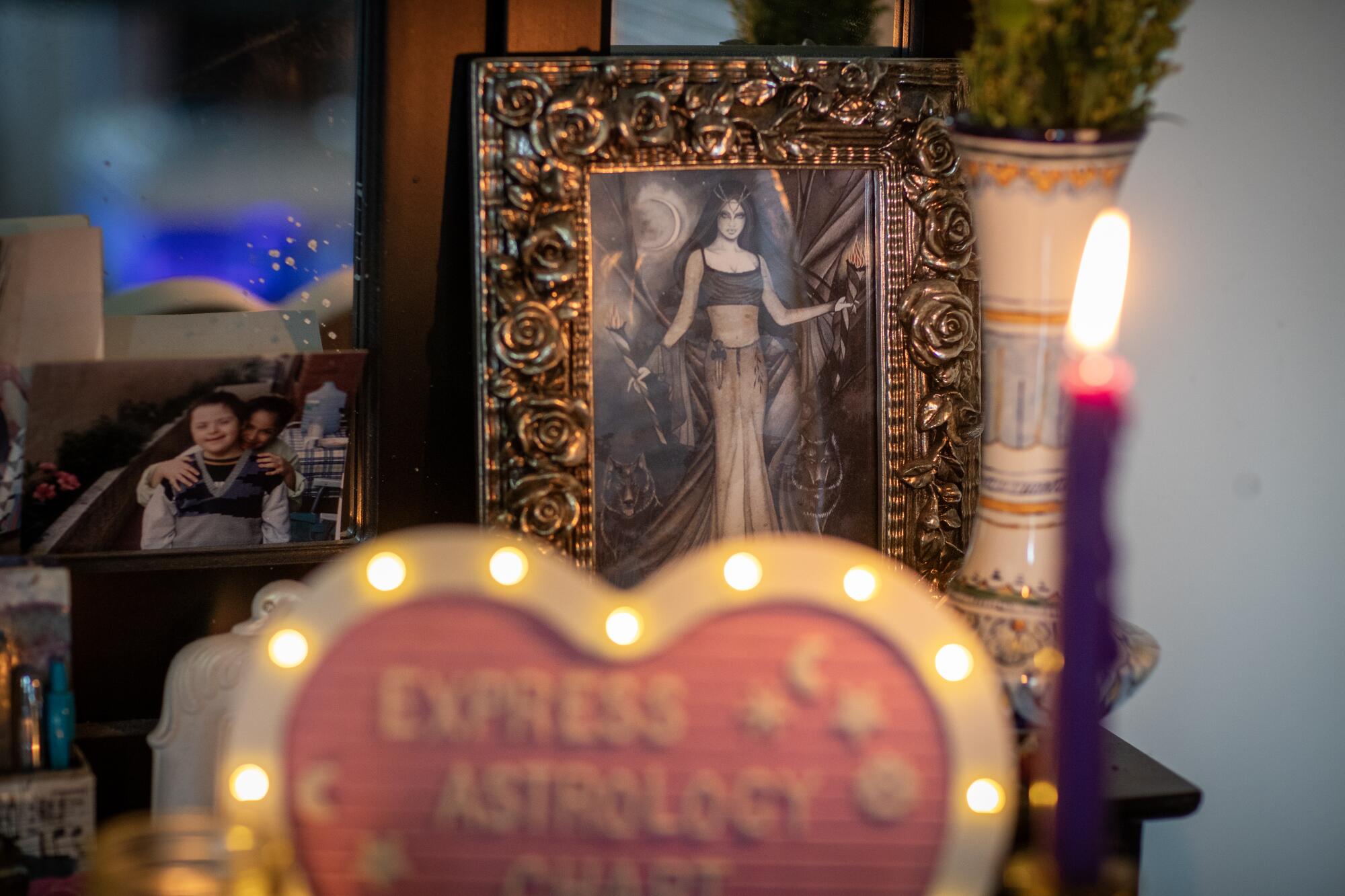 A photo and an image near a candle and a lighted heart that says Express Astrology chart. 