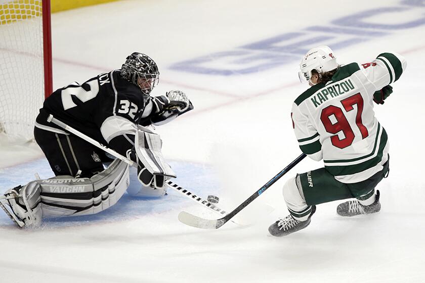 Minnesota's Kirill Kaprizov scores an overtime goal against the Kings' Jonathan Quick to give the Wild the victory on Thursday.