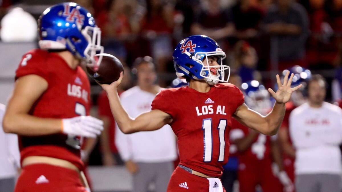 Los Alamitos High's Cade McConnell, pictured throwing a pass against Newport Harbor on Oct. 5, threw five interceptions in a 49-32 loss at Sherman Oaks Notre Dame in the CIF Southern Section Division 2 quarterfinals on Friday.