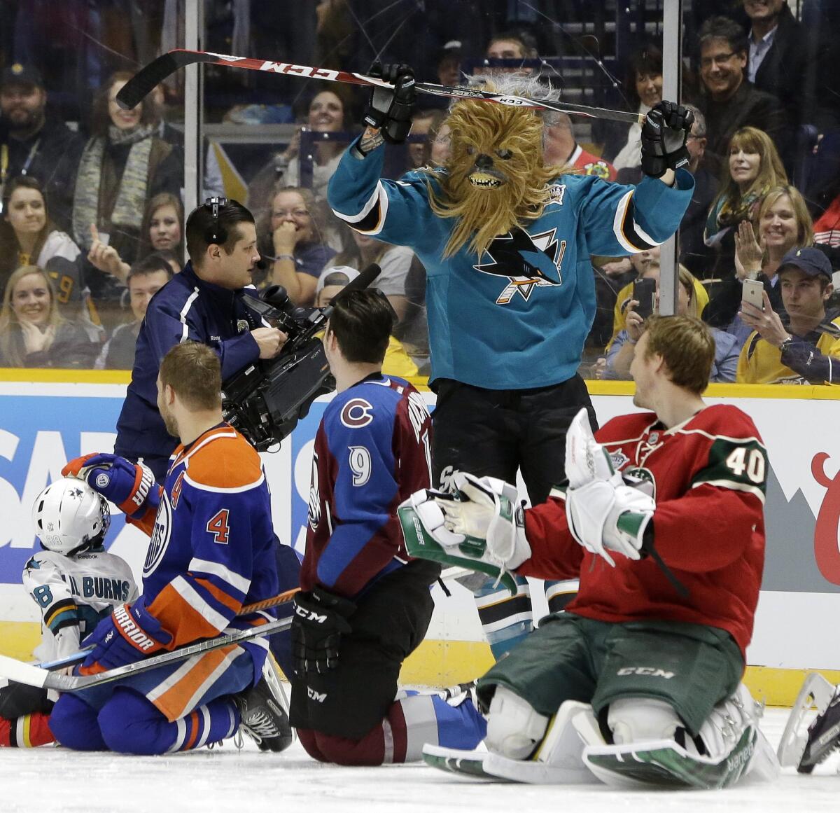 Sharks defenseman Brent Burns skates back to the bench wearing a Chewbacca mask after competing in the breakaway challenge at the NHL All-Star game skills competition.