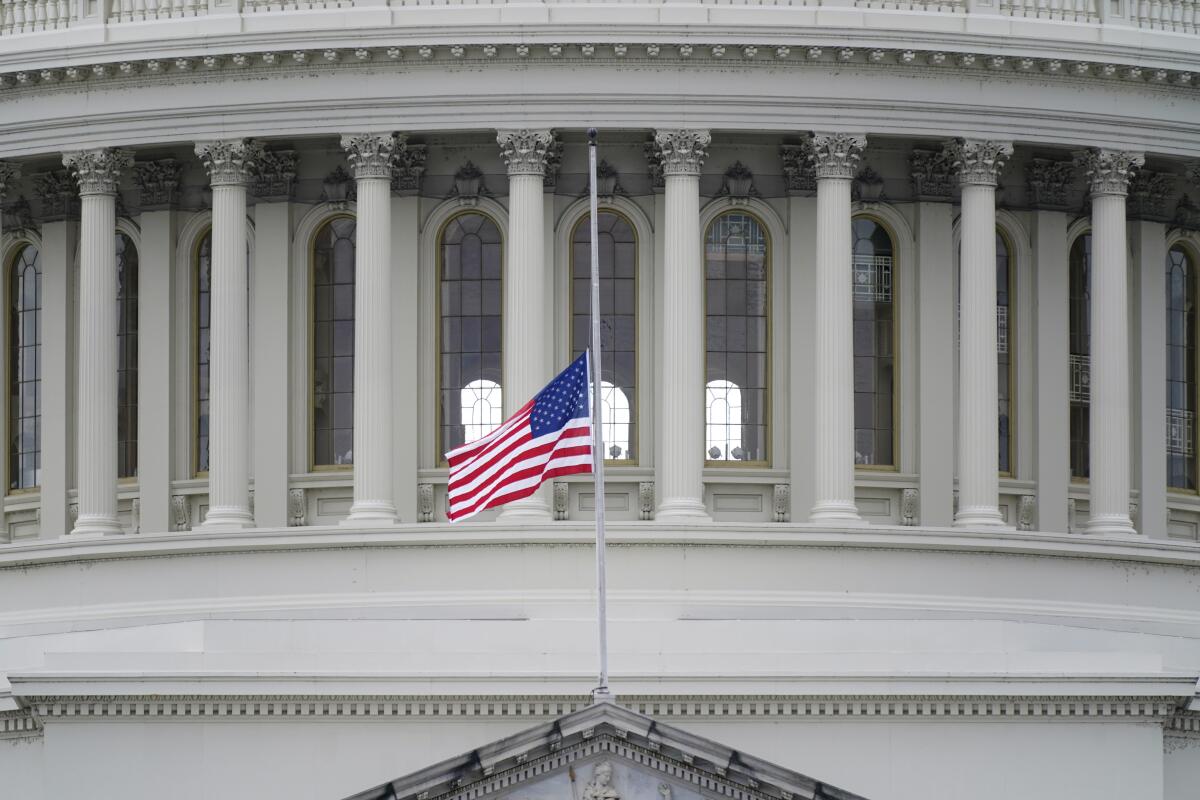 A flag flies at half-staff above the Capitol in honor of Capitol Police Officer Brian Sicknick on Jan. 8, 2021.
