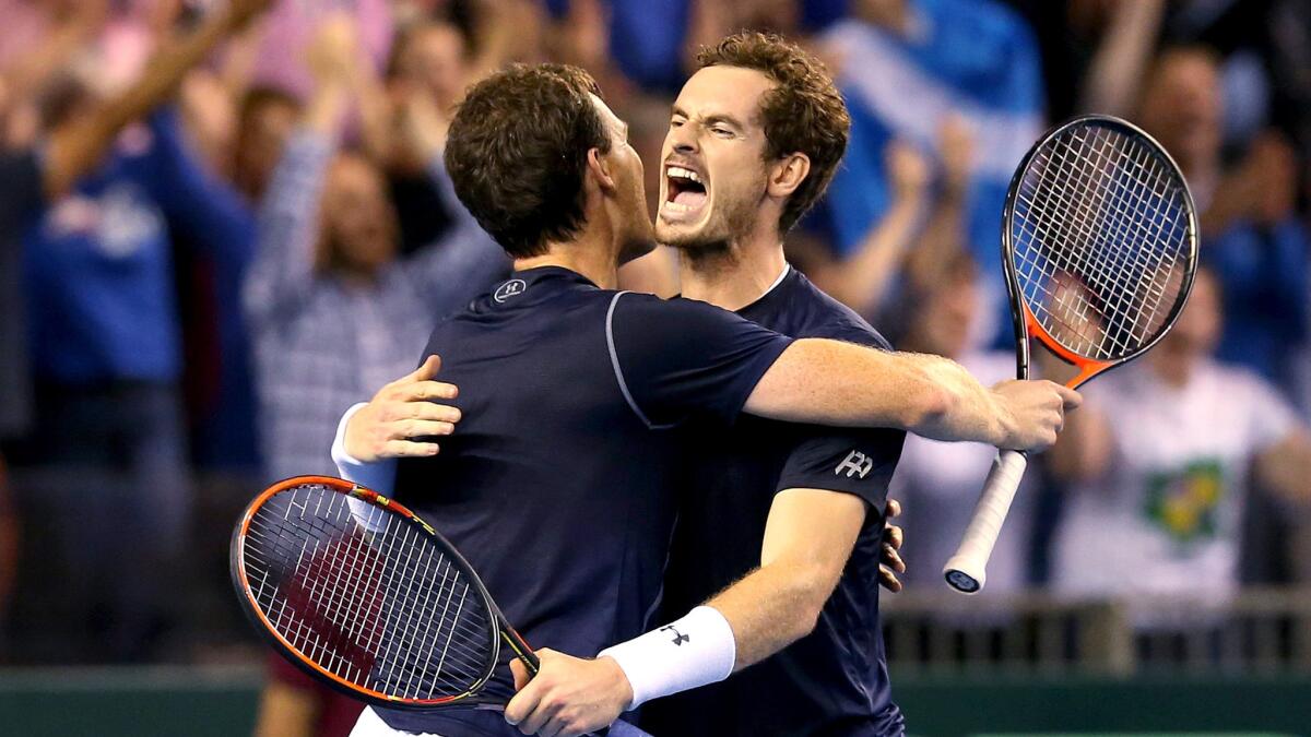 Brothers Jamie, left, and Andy Murray celebrate after defeating Australia's Sam Groth and Lleyton Hewitt in the doubles match during the Davis Cup semifinals on Saturday.