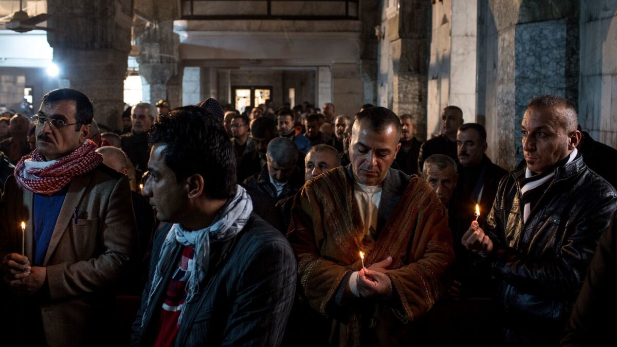 Iraqis attend Christmas Mass at the Mar Shimoni church in Bartella, a predominantly Christian town recently recaptured from Islamic State.
