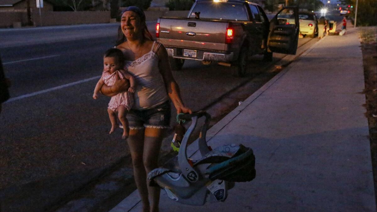 Dawn Inscore flees her Ridgecrest apartment after Friday night's magnitude 7.1 quake.