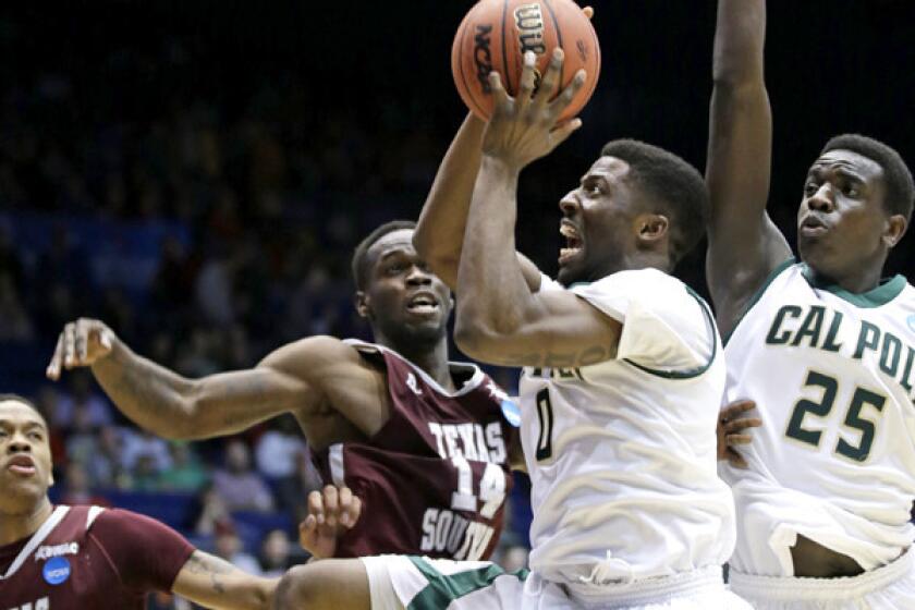 Cal Poly guard Dave Nwaba (0) drives to the basket against Texas Southern guard Ray Penn Jr. (14) in the first half Wednesday night in Dayton, Ohio.