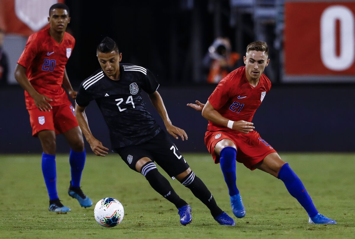 Mexico's Roberto Alvarado, middle, handles the ball against the U.S. in a friendly Sept. 6, 2019.  