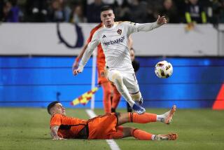 LA Galaxy forward Gabriel Pec, top, is tripped by Houston Dynamo defender Franco Escobar.