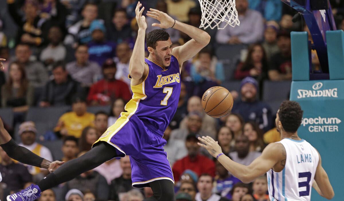 Lakers forward Larry Nance Jr. loses the ball as he drives against Charlotte Hornets' Jeremy Lamb (3) during the first half Tuesday. Nance later left the game after suffering an injury to his left knee.