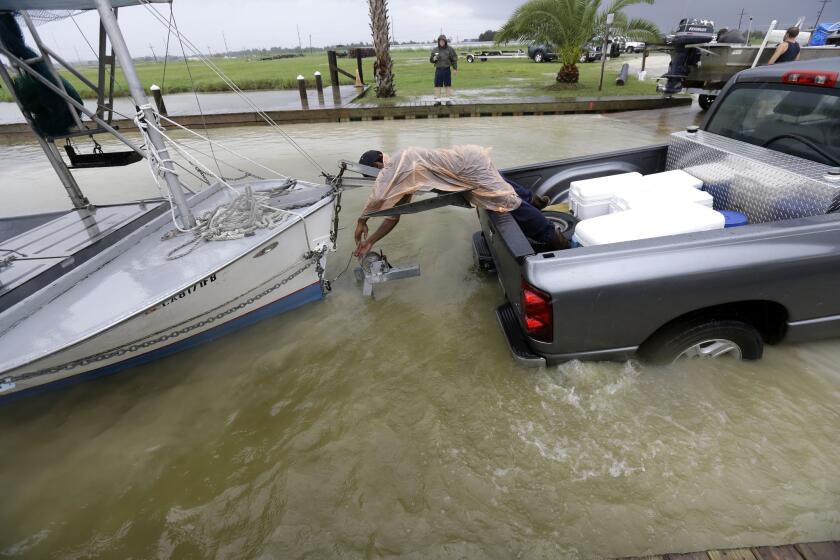 In Plaquemines Parish, south of New Orleans, C.J. Johnson pulls a boat out of the water in preparation for the arrival of Tropical Storm Karen.
