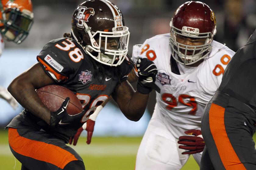 National team running back Travis Greene (38), of Bowling Green, runs against American team defensive lineman Antwaun Woods (99), of USC, during the second half of the NFLPA Collegiate Bowl in Carson on Jan. 23.