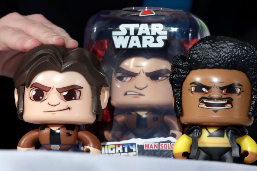FILE - In this April 26, 2018, file photo, the Star Wars Hans Solo Mighty Muggs, by Hasbro, are demonstrated at the TTPM 2018 Spring Showcase, in New York. Hasbro Inc. (HAS) on Monday, Oct. 22, reported third-quarter earnings of $263.9 million. (AP Photo/Richard Drew, File)