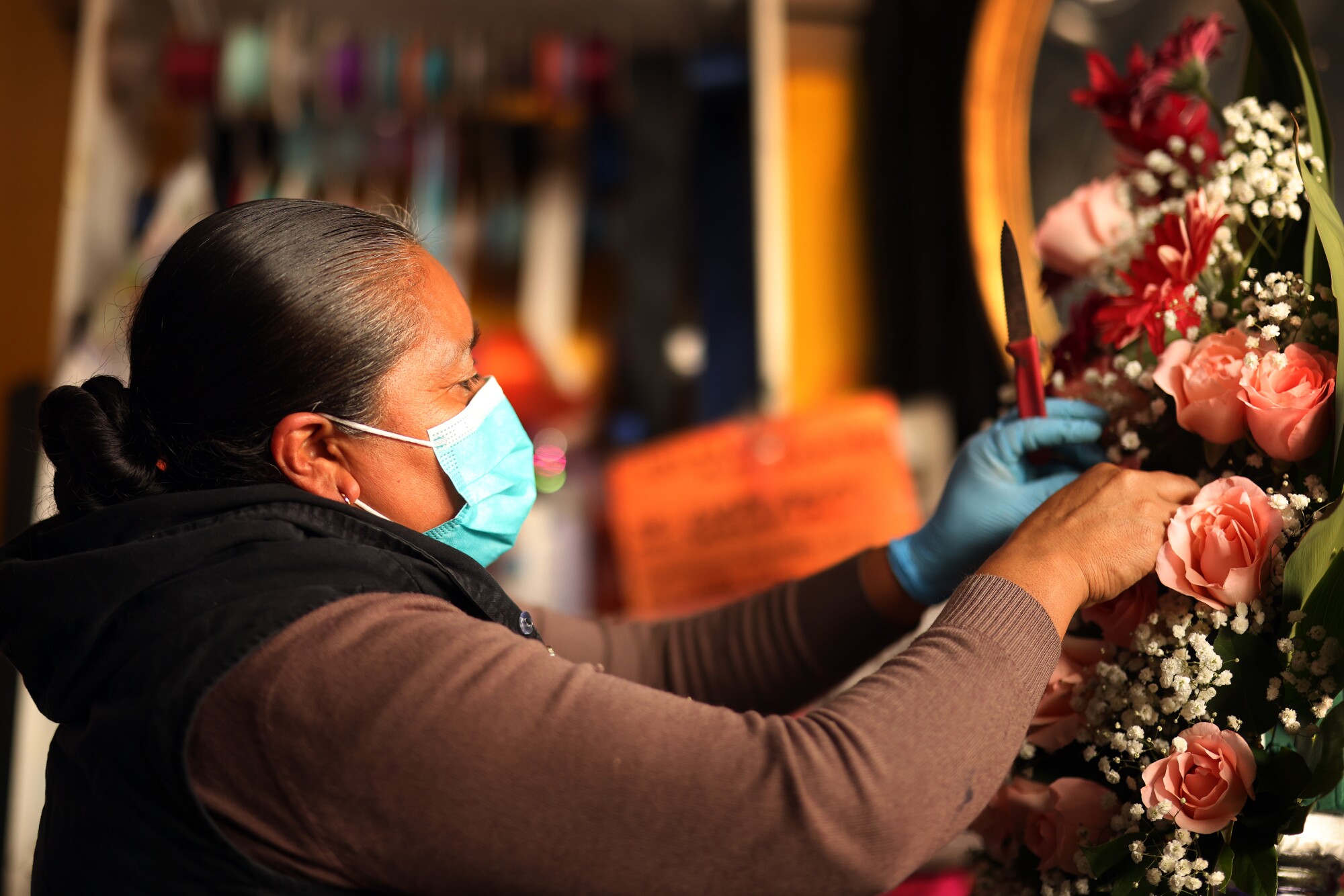 Paulina Olivarez arranges a bouquet for sale at California Flowers on Friday.