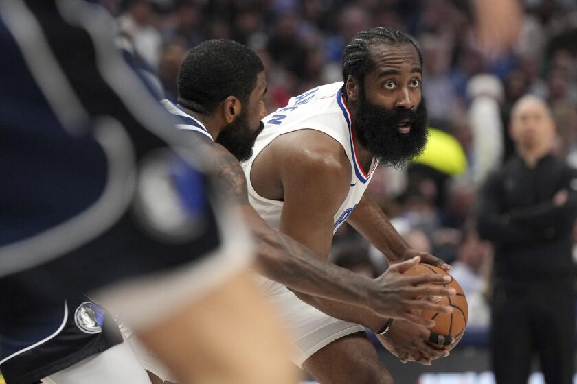 Los Angeles Clippers guard James Harden looks to pass as Dallas Mavericks guard Kyrie Irving defends during the first half of Game 4 of an NBA basketball first-round playoff series, Sunday, April 28, 2024, in Dallas. (AP Photo/Jeffrey McWhorter)