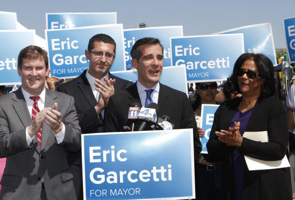 Then-Los Angeles mayoral candidate Eric Garcetti holds a news conference along with three former mayoral candidates who endorsed him: Kevin James, left, Emanuel Pleitez and Jan Perry at Barnsdall Park in April.