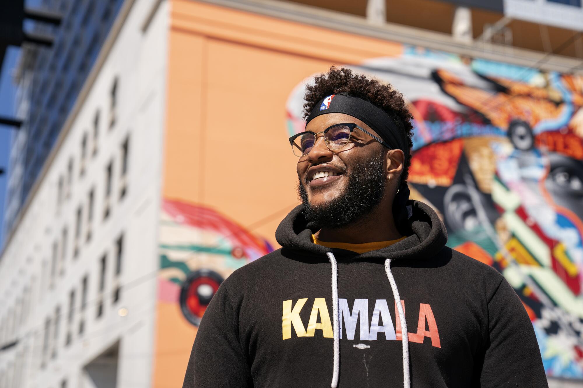 A closeup of a man wearing a hoodie that says "Kamala."