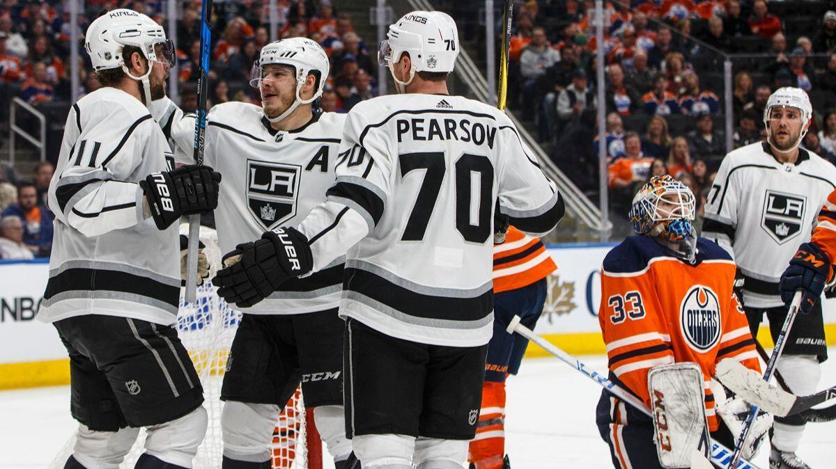 Kings' Anze Kopitar (11), Dustin Brown (23) and Tanner Pearson (70) celebrate a goal on Edmonton Oilers goalie Cam Talbot (33) during the third period on Tuesday.