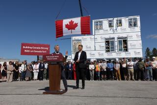 Mark Carney, Canada's prime minister, center left, speaks as Gregor Robertson, Canada's housing and infrastructure minister, center right, listens during a news conference outside of a modular housing site in Ottawa, Ontario, Canada, on Sunday, Sept. 14, 2025. Carney launched a new government agency responsible for building affordable homes as he aims to boost the pace of construction over the next decade. Photographer: David Kawai/Bloomberg